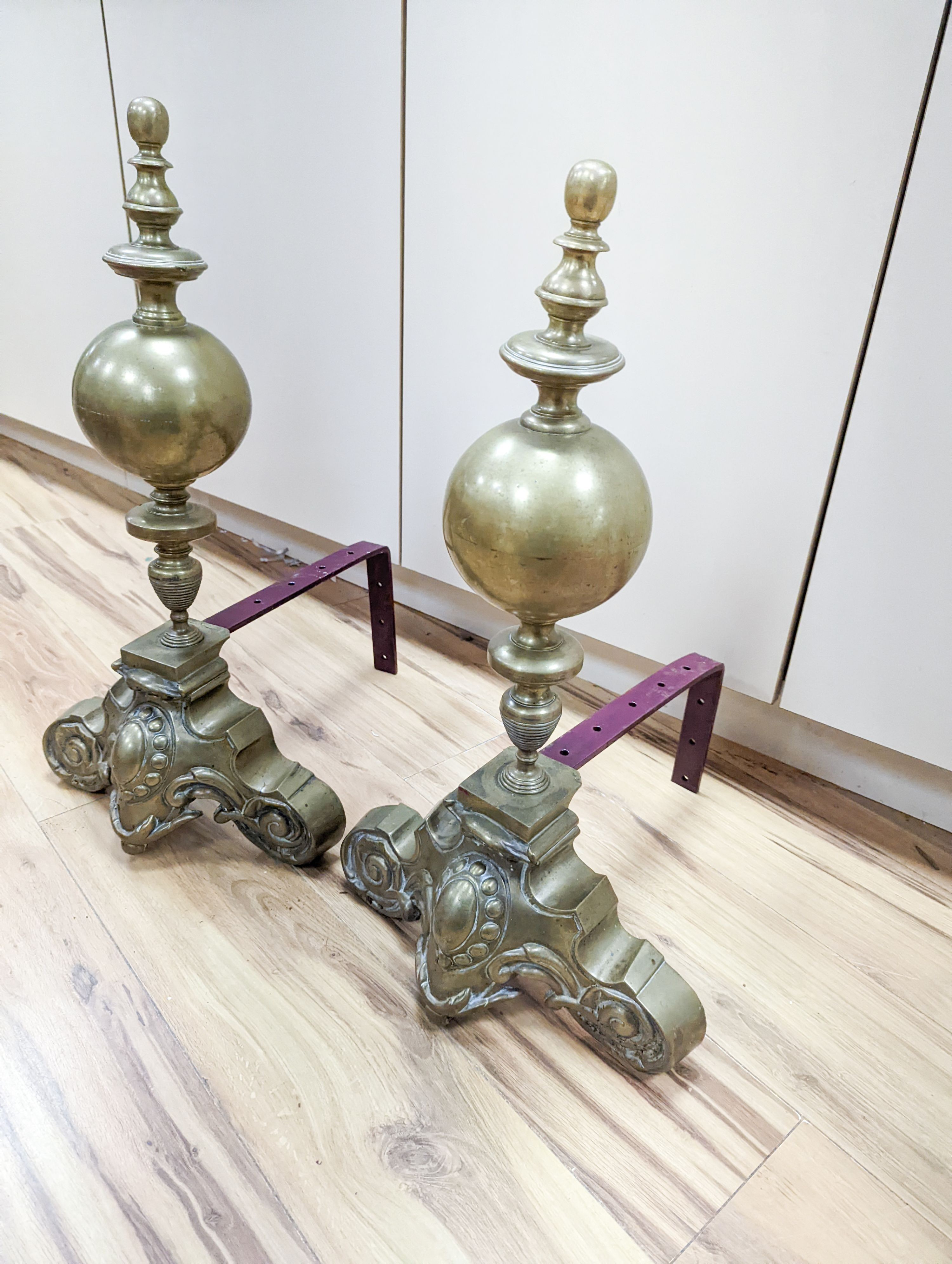 A pair of brass and iron fire dogs 62cm